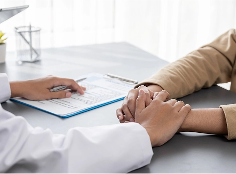 Doctor holding patients hand