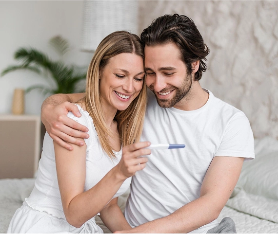 Happy Couple holding pregnancy test kit