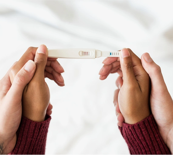 Husband and wife holding Pregnancy Kit