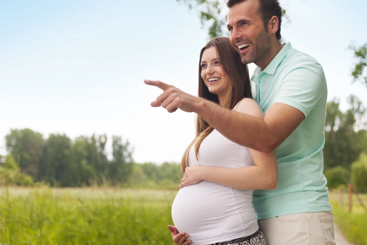 happy excited couple pregnant looking away