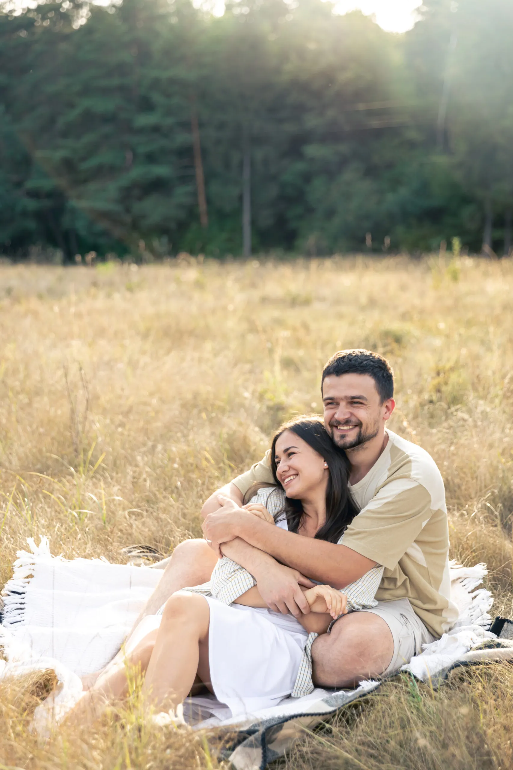 happy married man and woman date relaxing in field