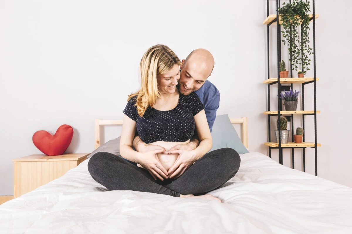 husband sitting pregnant woman