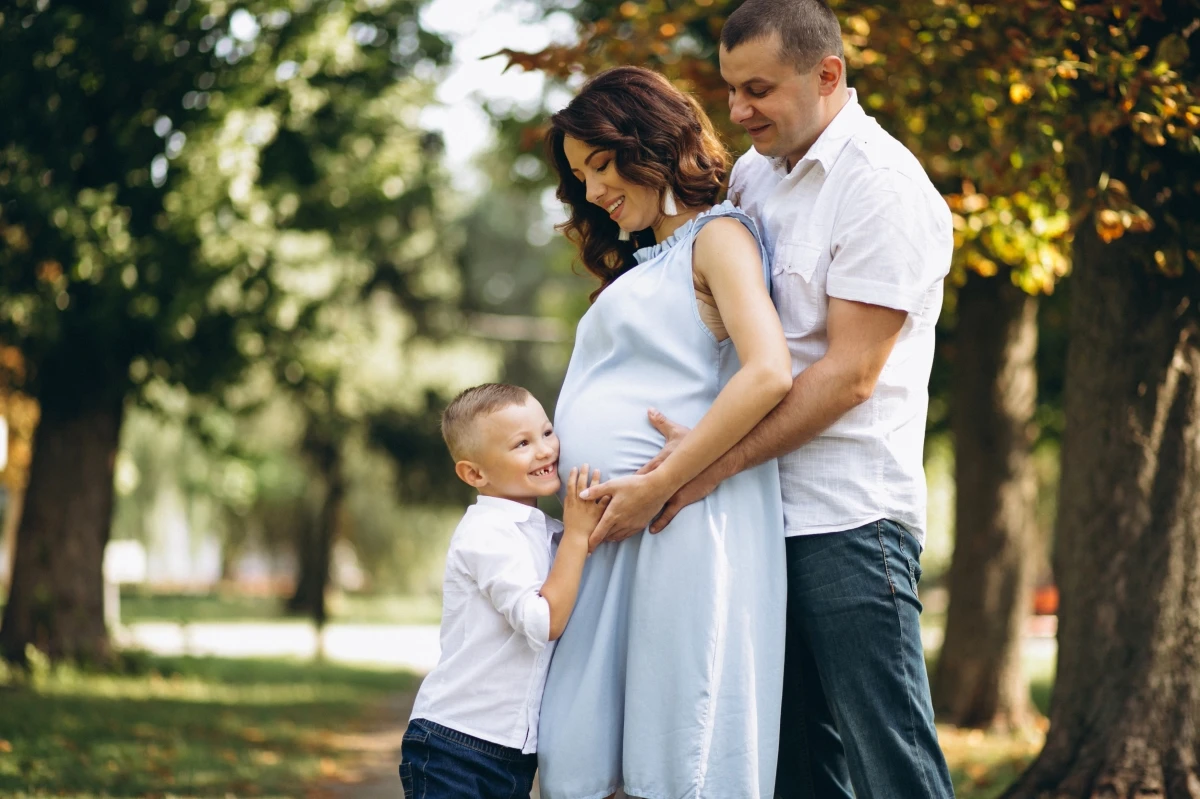 husband with pregnant wife their son park