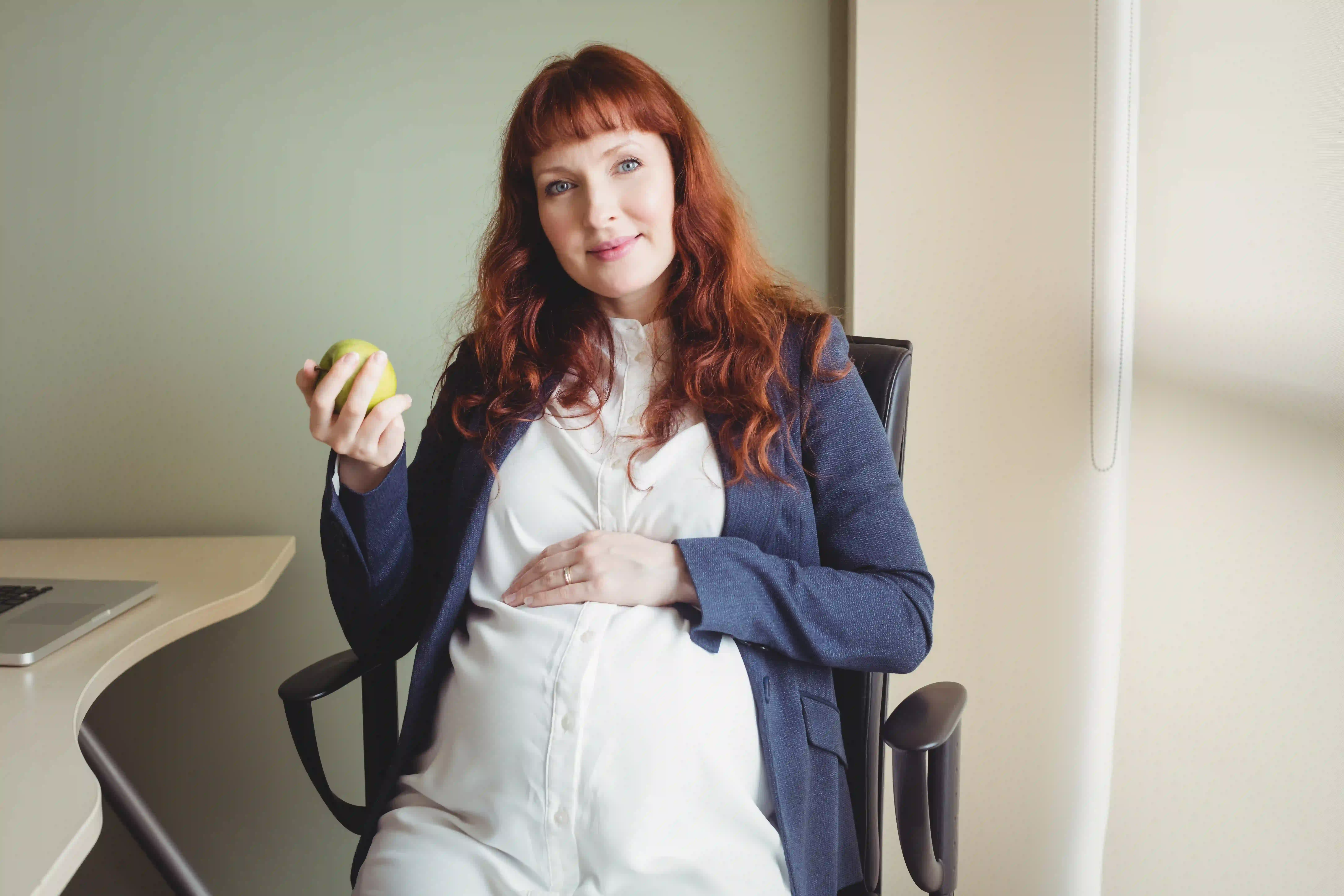 portrait-pregnant-businesswoman-holding-apple Benefits of Receiving Anovulation Treatment