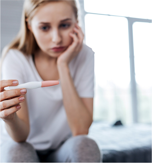 woman holding a pregnancy test