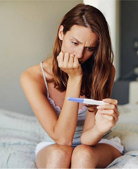 woman holding pregnancy test kit img